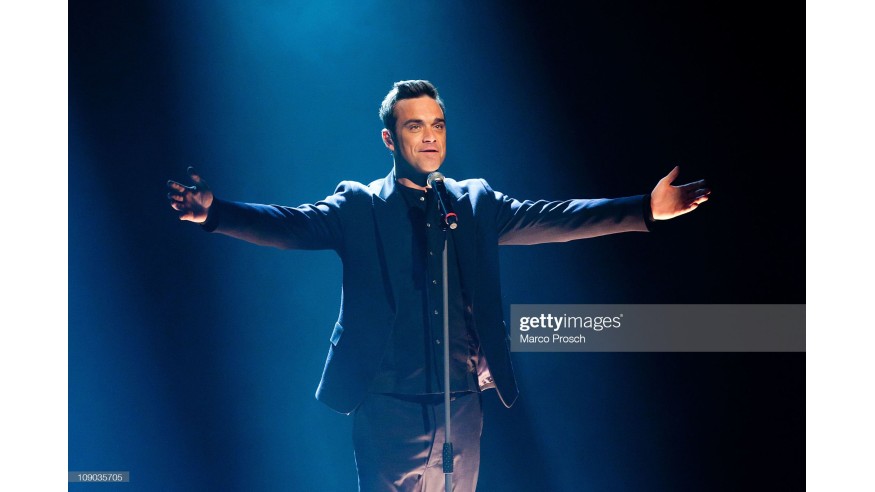 HALLE, GERMANY - FEBRUARY 12: Robbie Williams of Take That performs during the 193th 'Wetten, Dass...?' show at the Messe Halle on February 12, 2011 in Halle, Germany. (Photo by Marco Prosch/Getty Images)