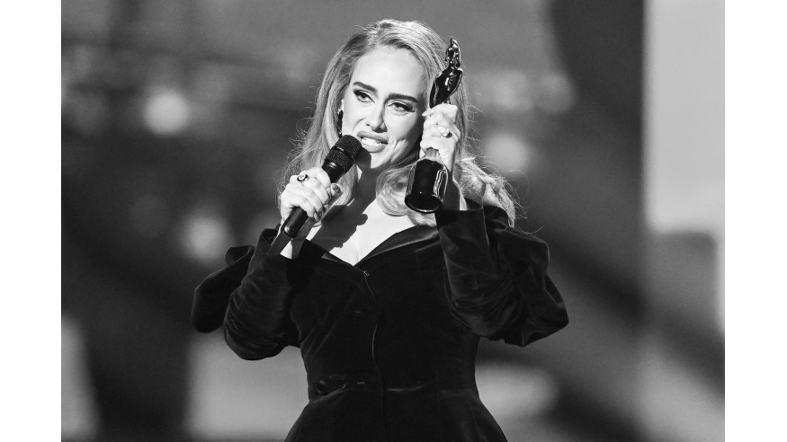 LONDON, ENGLAND - FEBRUARY 08: (EDITORS NOTE: image converted to black and white) EDITORIAL USE ONLY Adele accepting the Mastercard Album of the Year award for "30" during The BRIT Awards 2022 at The O2 Arena on February 08, 2022 in London, England. 